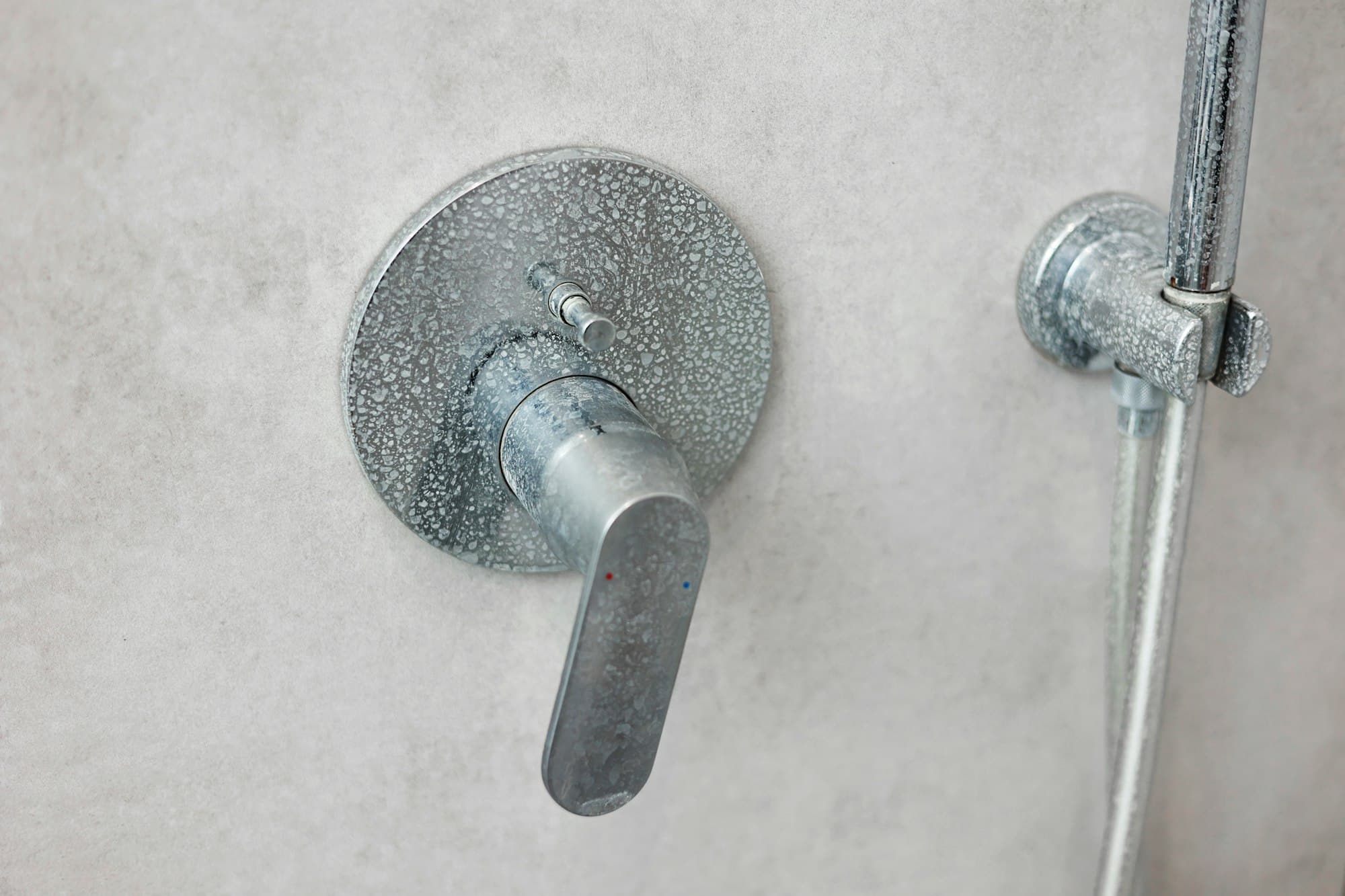 Dirty calcified shower mixer tap, faucet with limescale on it, plaque from hard water, Chrome plate